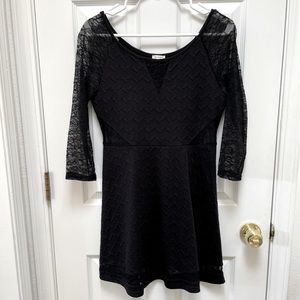 Black party dress with lace cut out details. Very lightly worn.